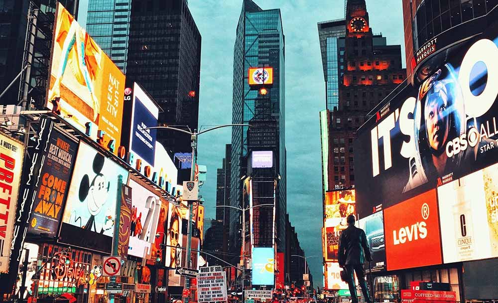 NYC street with advertisements and print marketing from many brands
